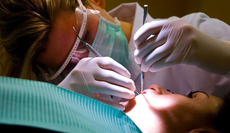 Dentist Examining Patient's Teeth