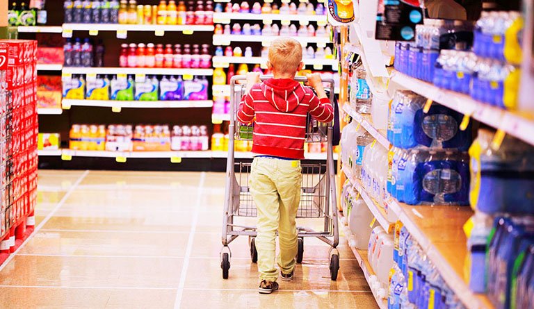 Kid Pushing Shopping Cart In Supermarket