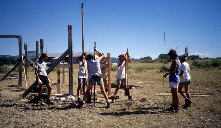 Students Digging Holes In A Field