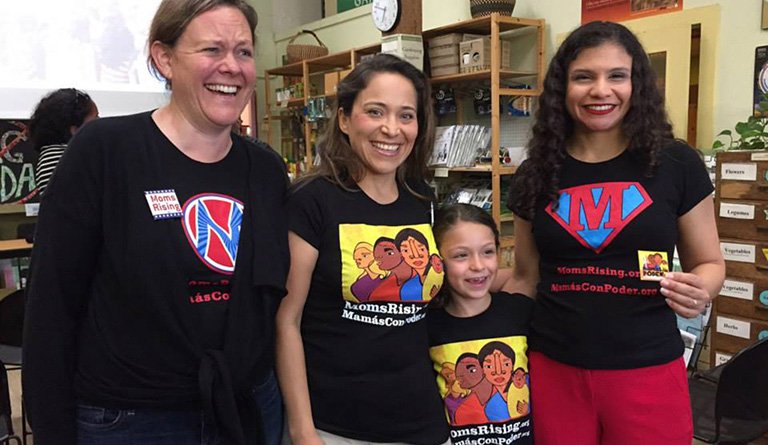 Women And Girls Wearing Mom's Rising Good Food Force T-shirts