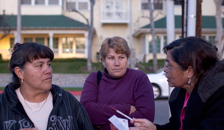 Latino Women Having A Discussion On A Residential Block