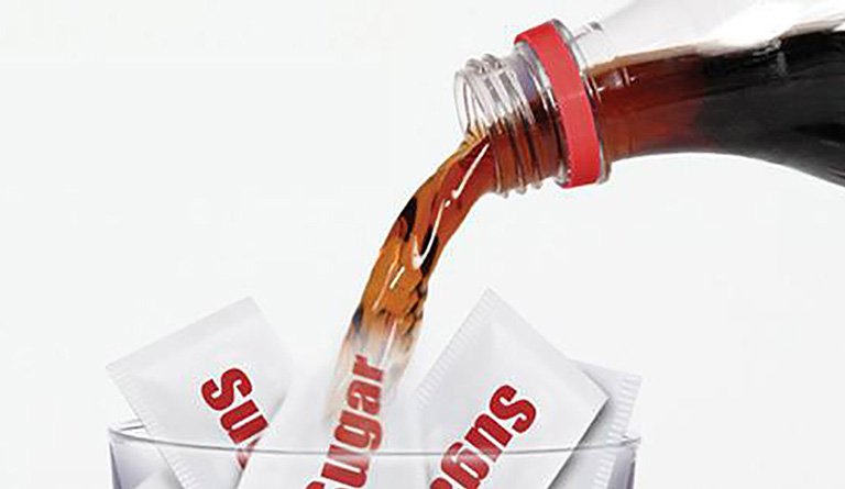 Soda Being Poured Into A Coup With Sugar Packets