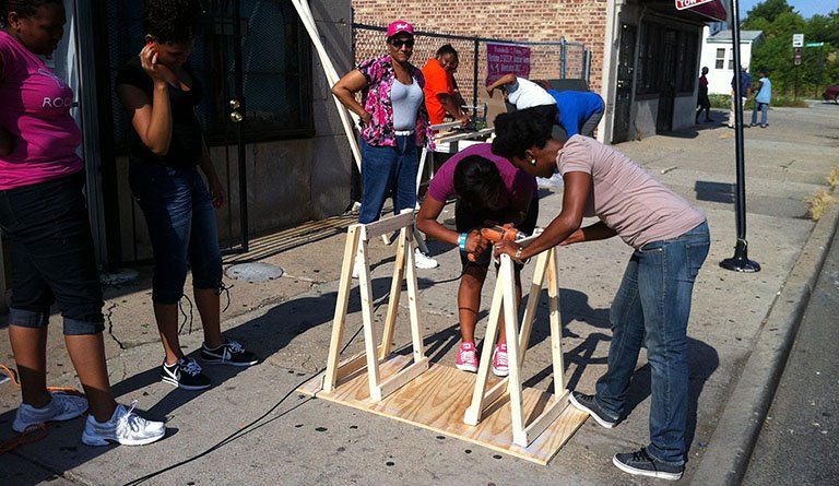 Students Working To Assemble A Wooden Structure Outside