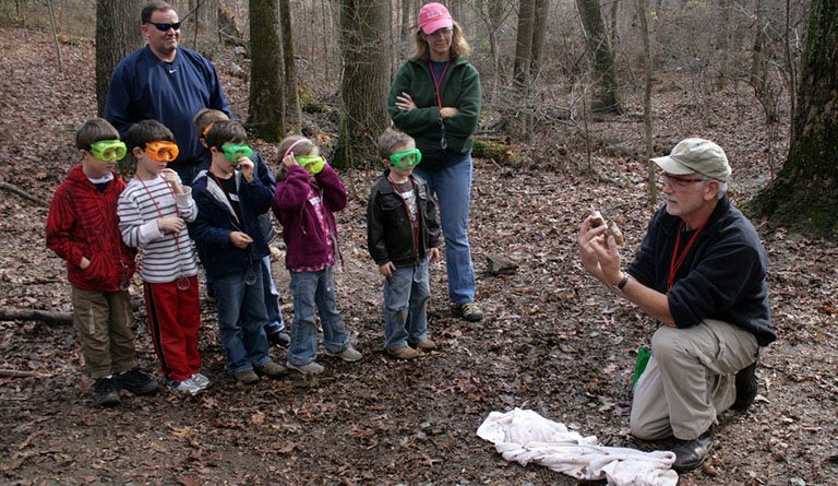 Instructors Talking With Students In Forest